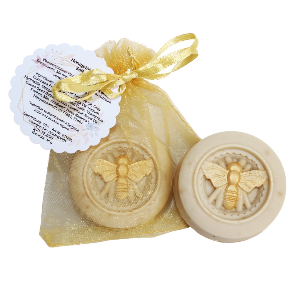Honigseife rund Eine rund Seife mit einem goldenen Bienenmotiv in der Mitte. Verpackt in einem leicht goldenen Organzasäckchen.